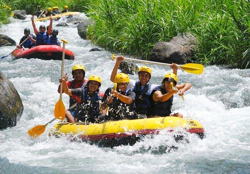People enjoying white water rafting on Telaga Waja River